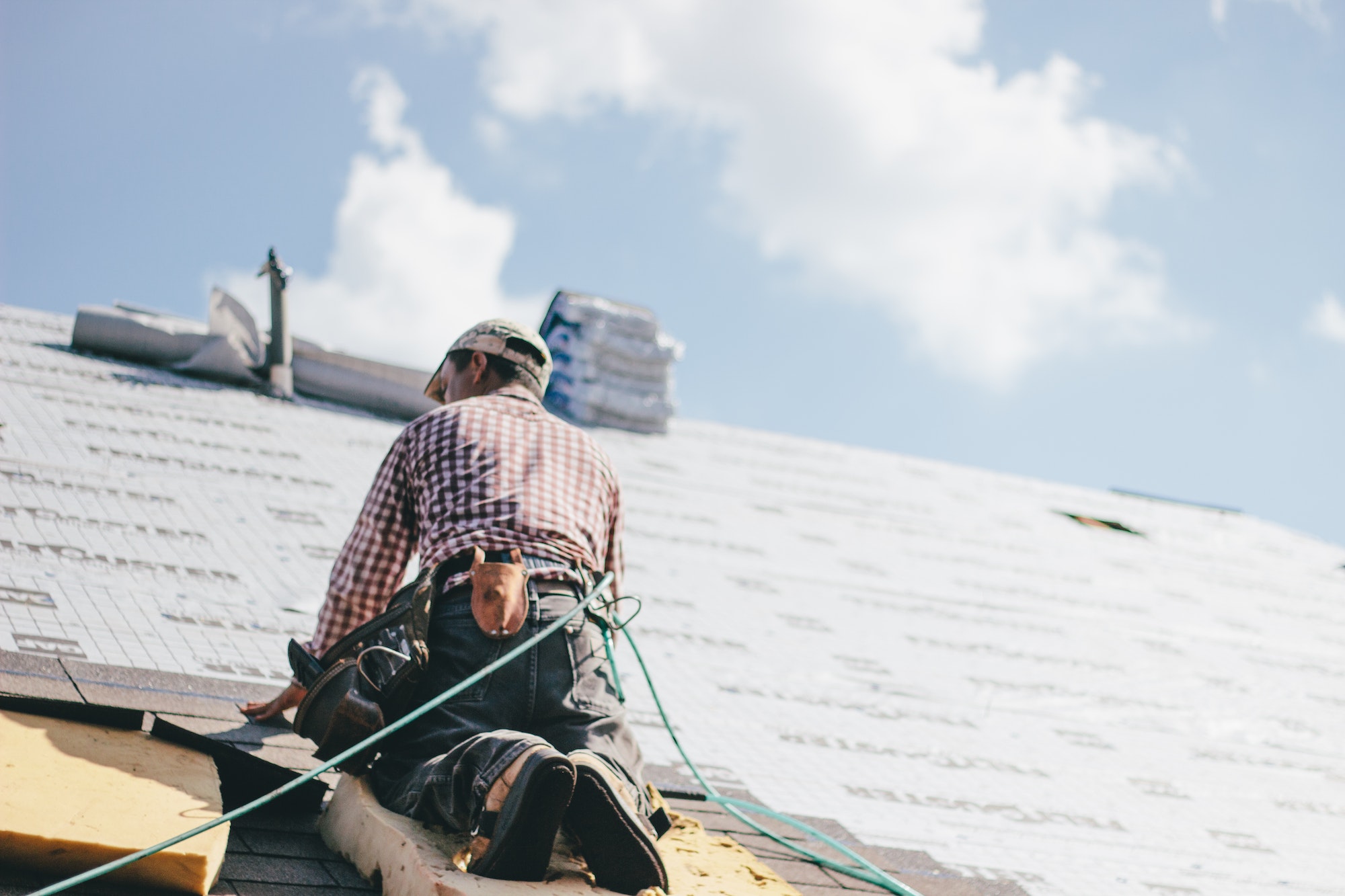 roofer-adding-shingles-to-the-roof-of-a-house.jpg